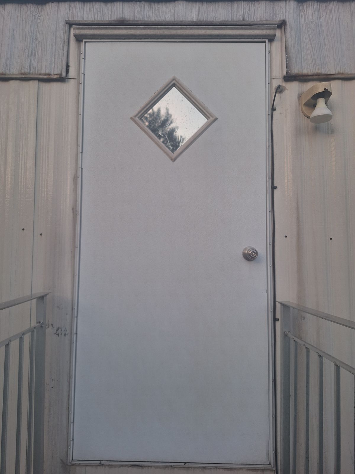 The same steel door, rust-free with its finish intact, after rust removal