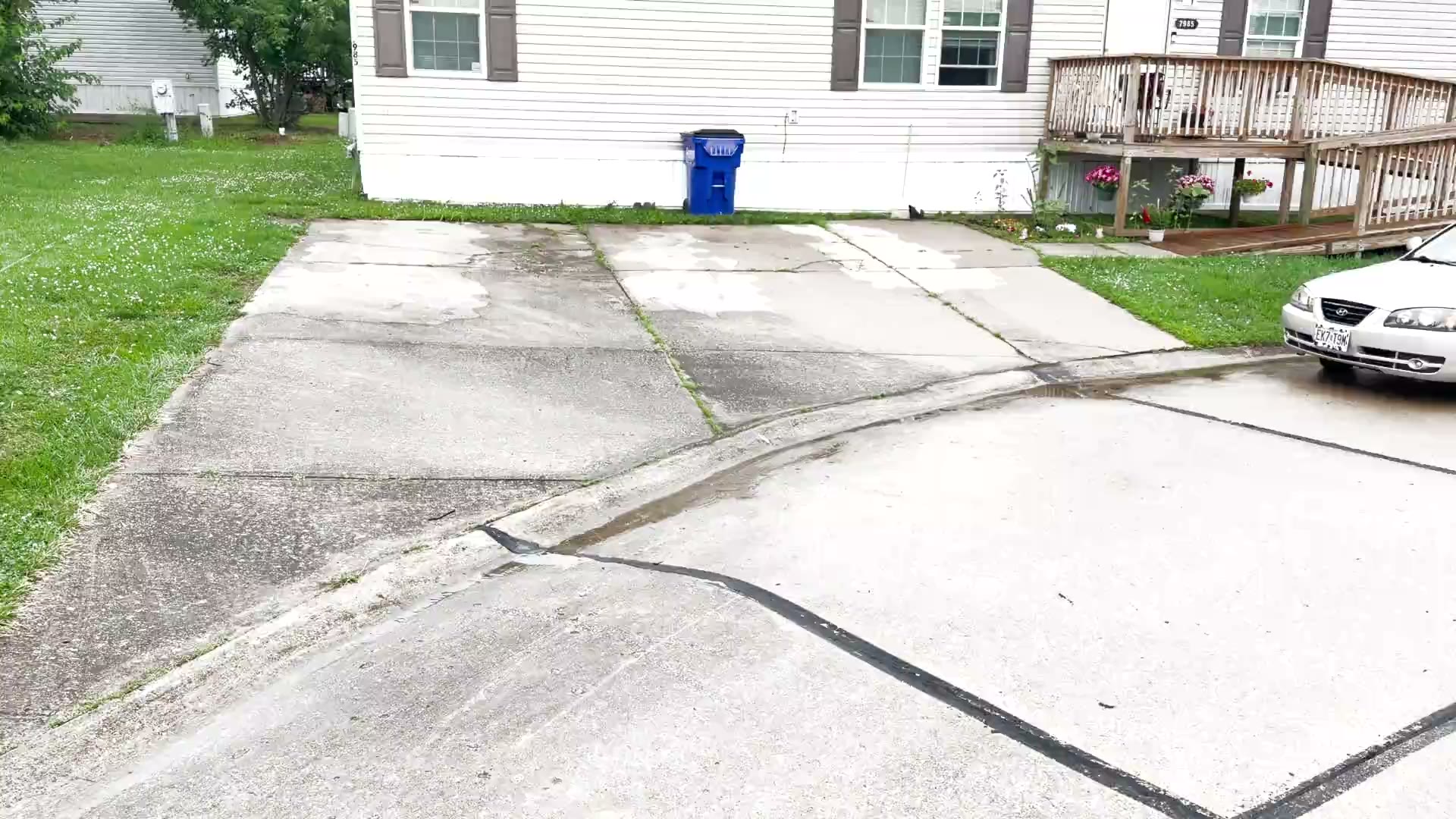 Dirty concrete driveway about to be surface-cleaned